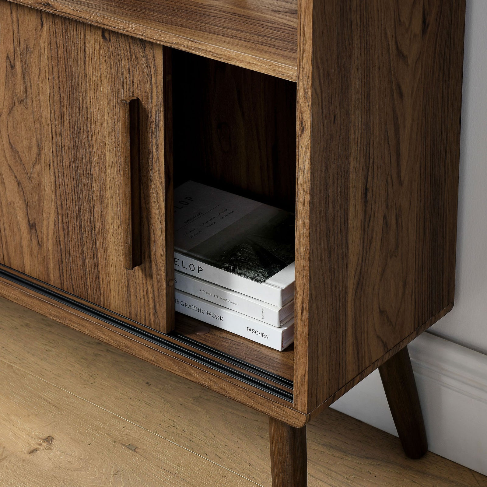 Lower shelf stores books within easy reach, framed by rich walnut grain || EEI-7193-WAL || storage_room