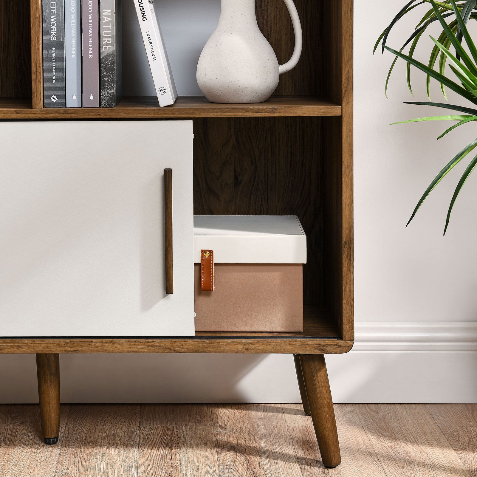 Hidden storage behind the white sliding door keeps clutter out of sight while walnut grain adds warmth || EEI-7194-WAL-LIN || storage_open_room