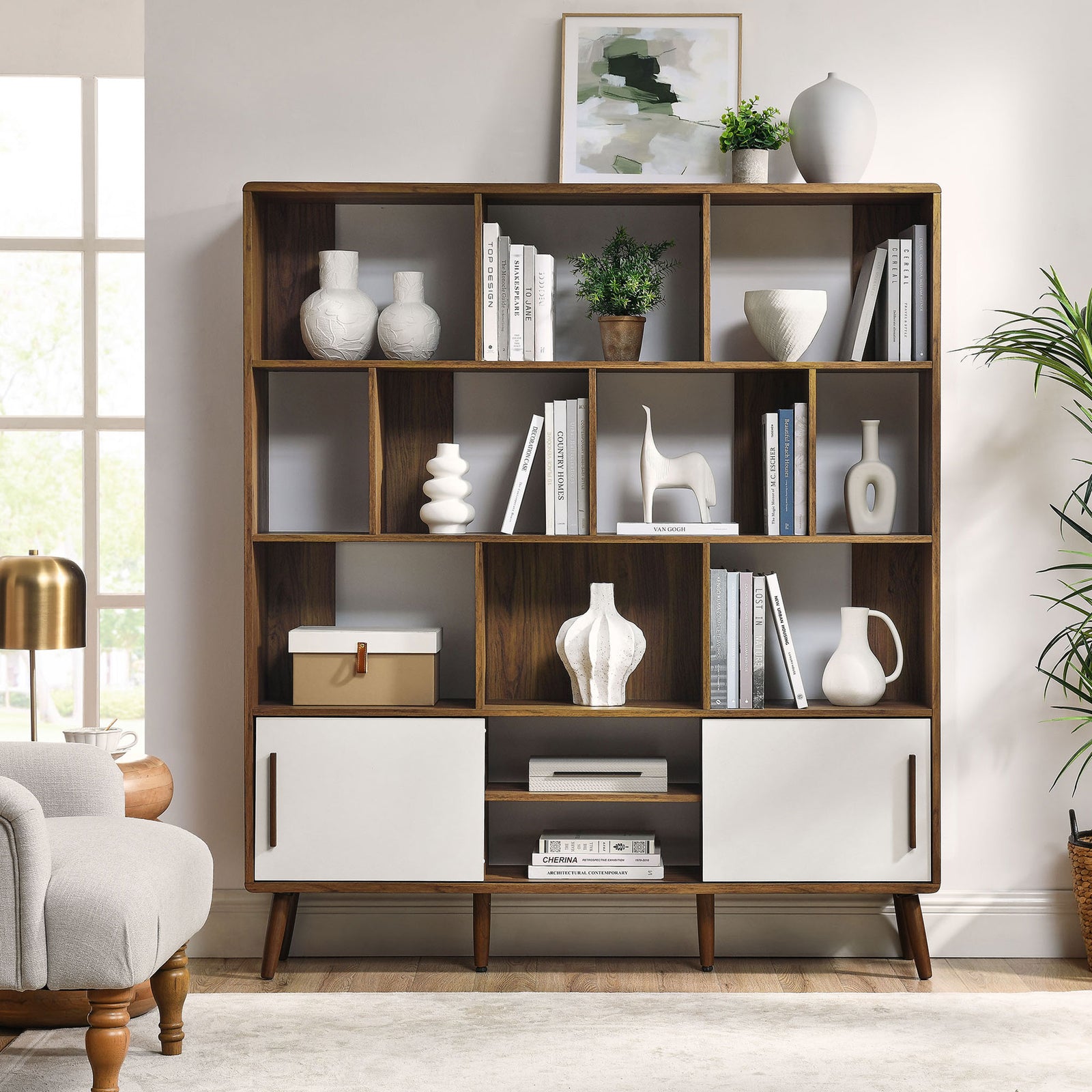 Styled shelves and concealed storage combine for a polished living room focal point in warm walnut and white || EEI-7194-WAL-LIN || front_room