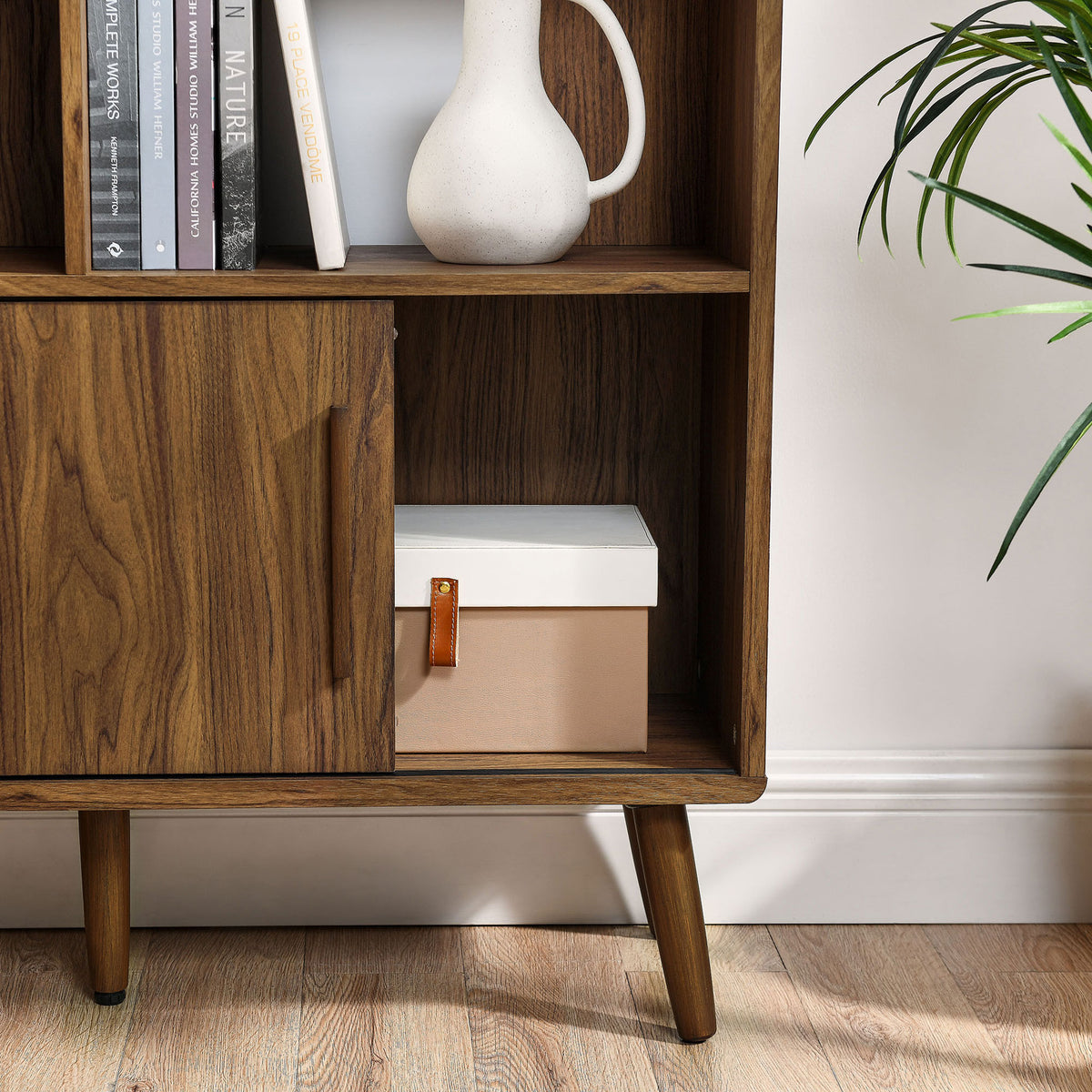 Concealed cabinet keeps essentials neatly tucked behind a smooth sliding door || EEI-7194-WAL || storage_open_room