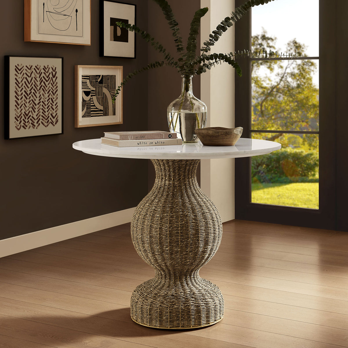 Versatile marble and seagrass pedestal table styled as an elegant accent piece in a warm modern interior || EEI-7195-WHI-NAT || front_angle_room