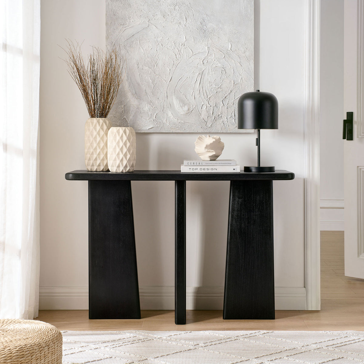 Elegant console with bold geometric legs and a sleek black finish for modern spaces || EEI-7197-BLK || front_room