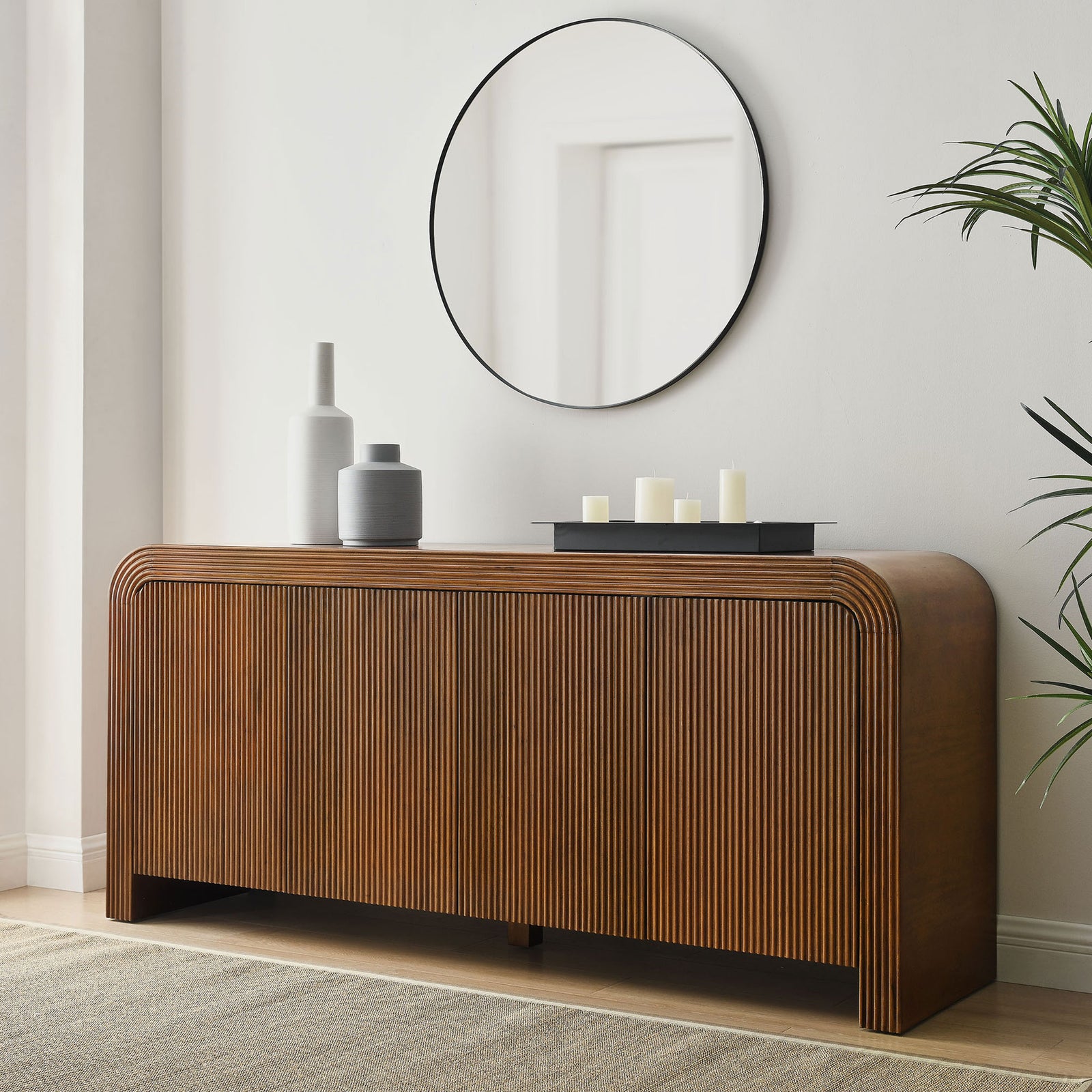 Walnut fluted cabinet styled with modern vases and round mirror, bringing warm texture to an airy entryway || EEI-7198-WAL || front_angle_room