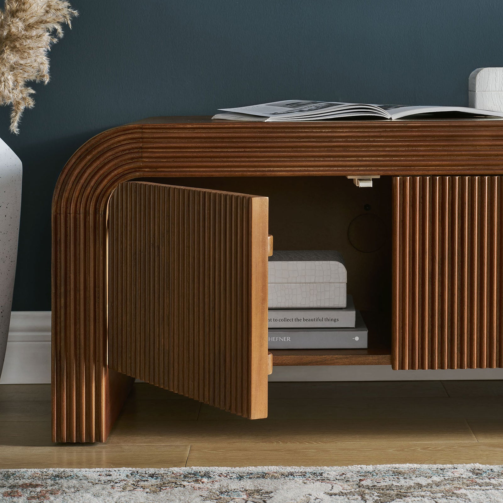 Styled walnut TV stand cabinet with one door open to show interior shelving and decor || EEI-7199-WAL || storage_open_room