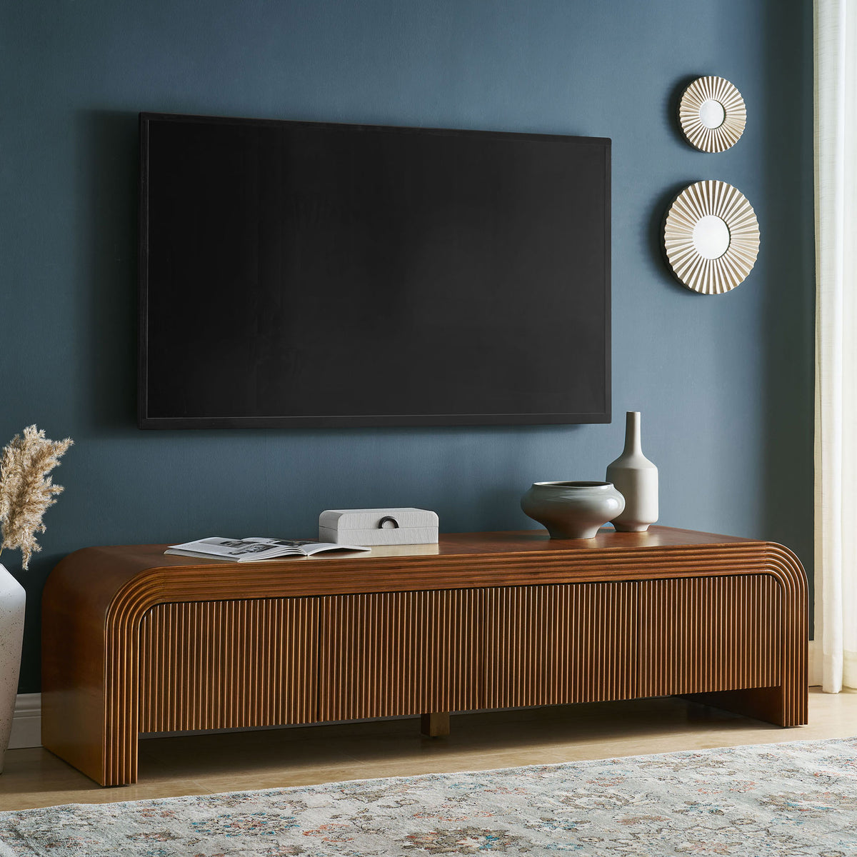 Walnut fluted TV stand anchors a modern living room with low profile and ample surface space || EEI-7199-WAL || front_angle_room