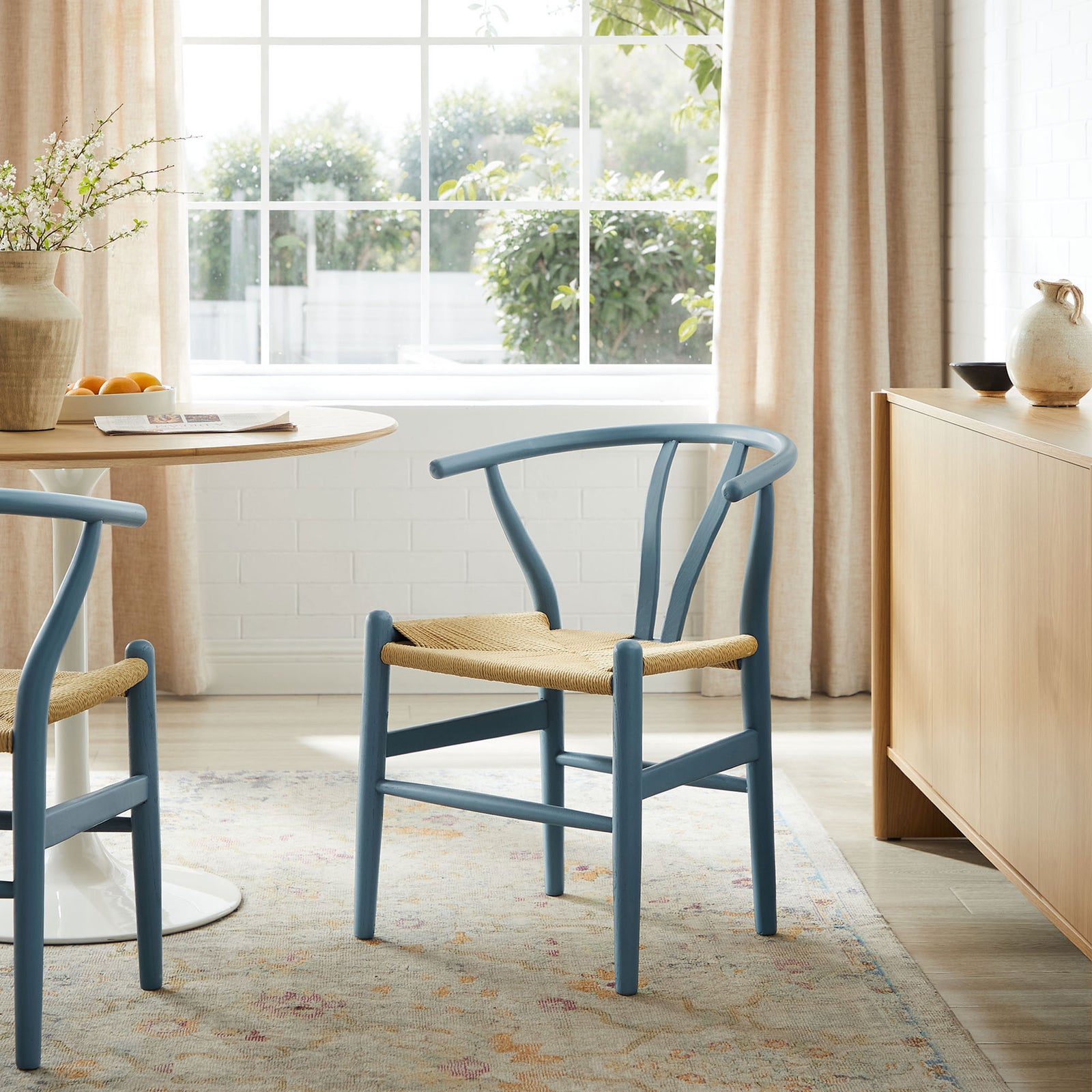 Harbor blue wood dining chair with rope seat styled in airy breakfast nook with light wood table || EEI-7200-HAR || front_angle_room