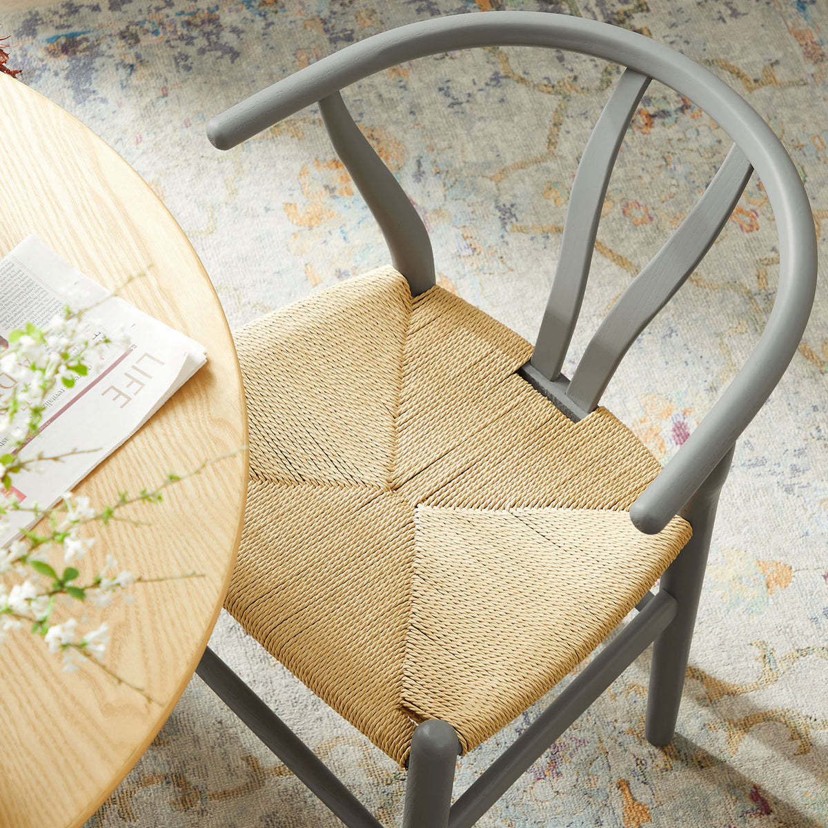 Top view of chair at dining table showing paper rope seat pattern and smooth gray frame in use || EEI-7200-LGR || detail_room
