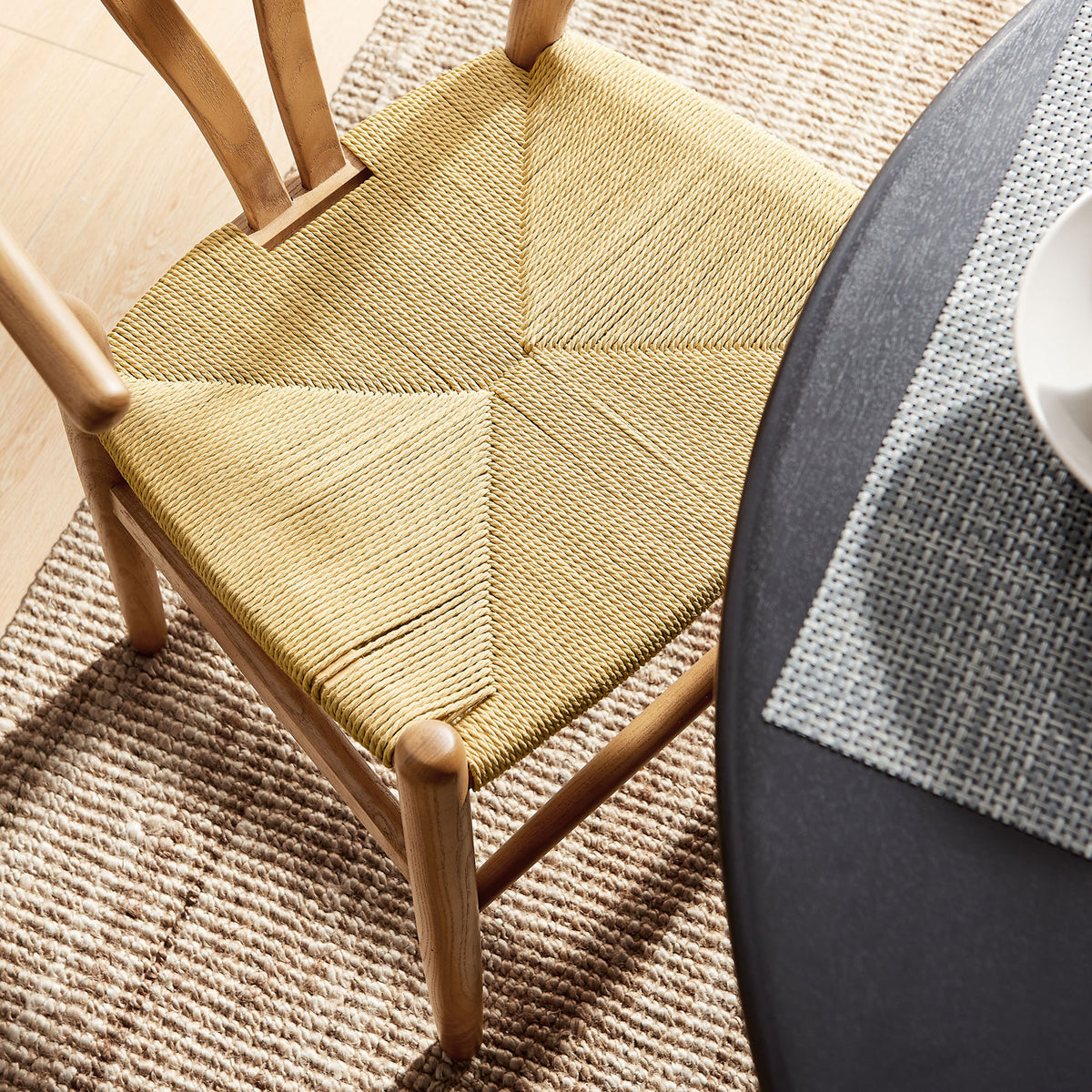 Natural rope seat pairs with a woven rug and modern table setting to create a relaxed dining look || EEI-7200-WAL || detail_room