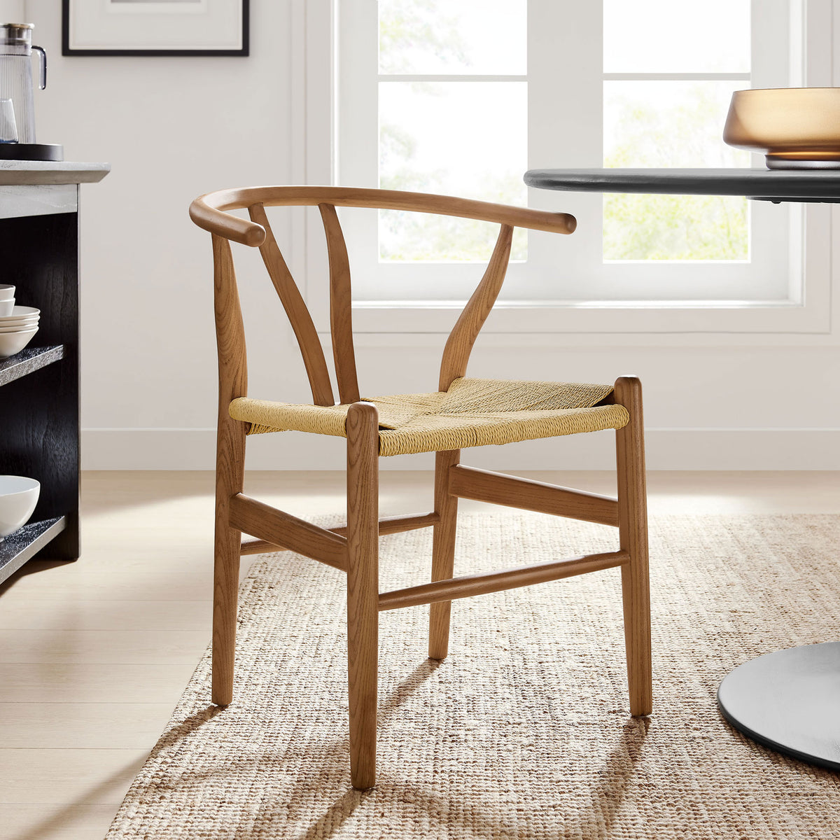 Walnut rope-seat dining chair anchors a bright modern dining room with soft natural light || EEI-7200-WAL || front_angle_room