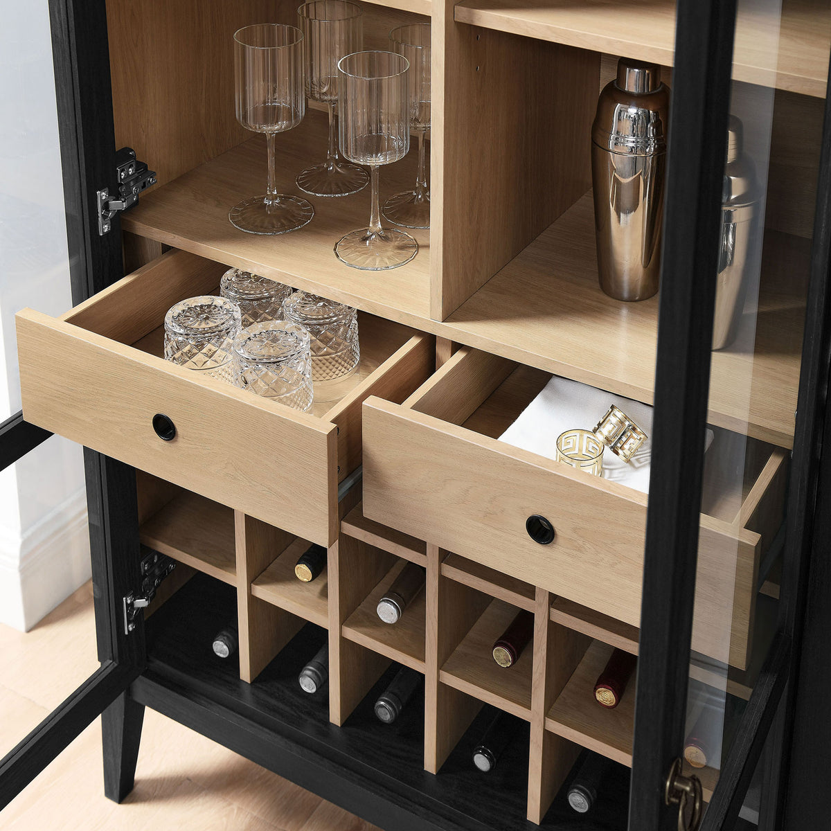 Real-life setup shows glasses, mixers, and bottles neatly arranged in the drawers and wine rack || EEI-7203-BLK-OAK || storage_open_room