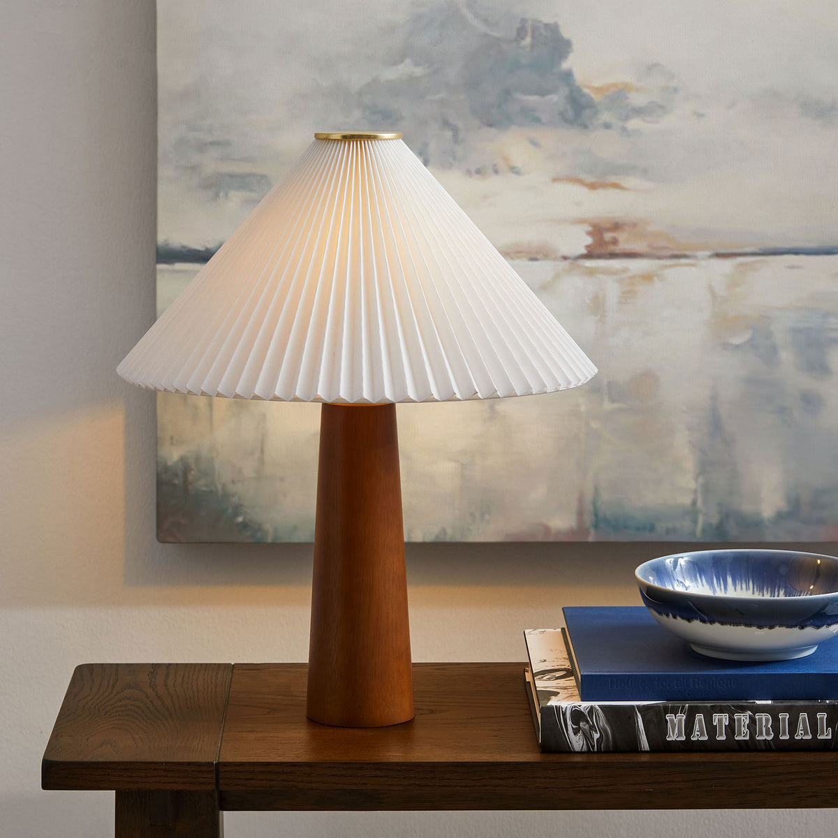 Table lamp casting warm light on console table to create a cozy room ambiance || EEI-7212-WAL || front_on_room