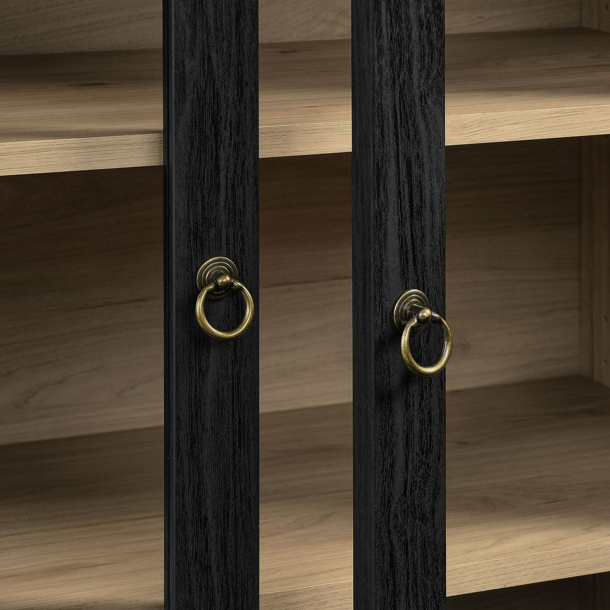 Brass ring pulls on black wood grain doors with warm light oak backdrop || EEI-7216-BLK-LOA || handle_studio