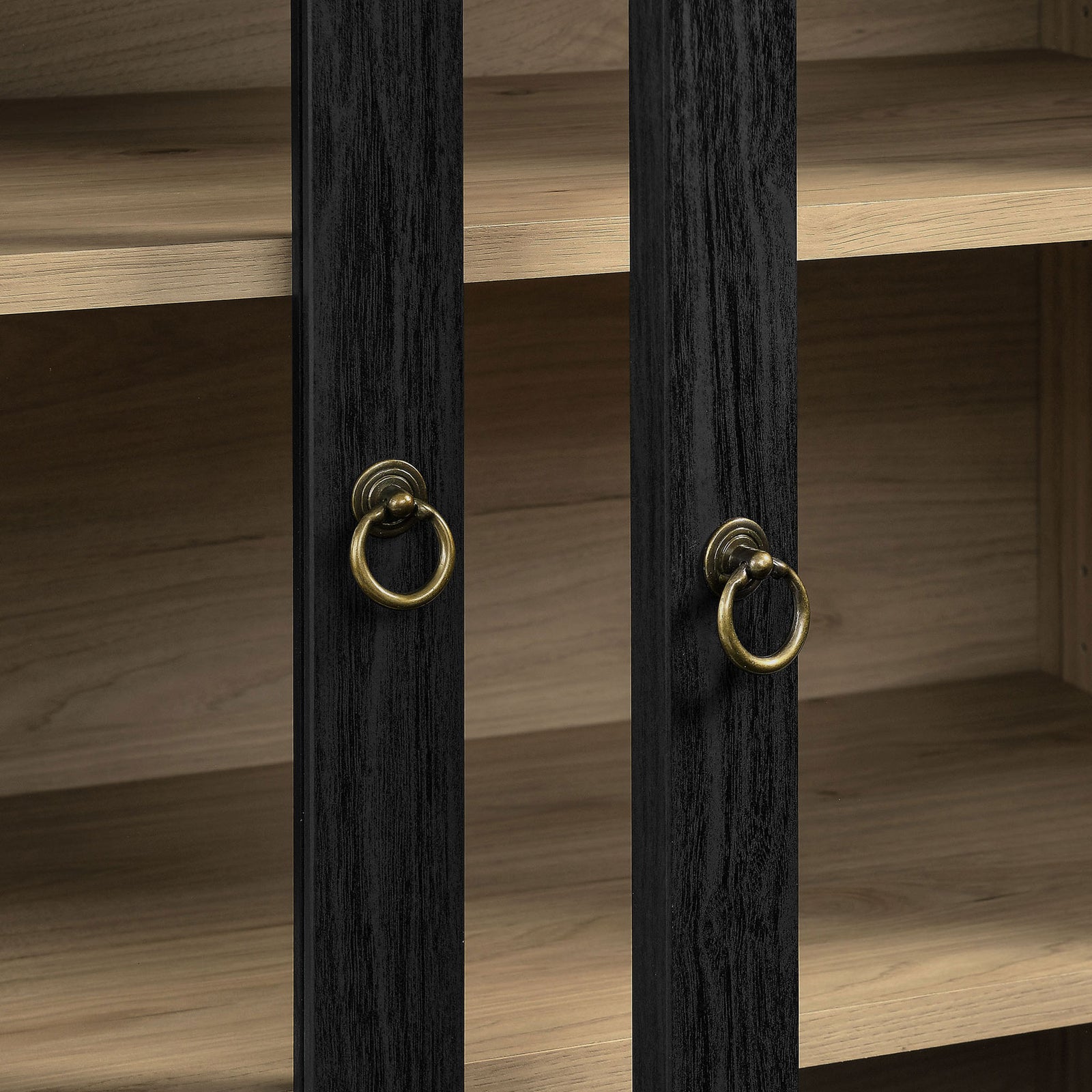 Brass ring pulls on black wood grain doors with warm light oak backdrop || EEI-7216-BLK-LOA || handle_studio