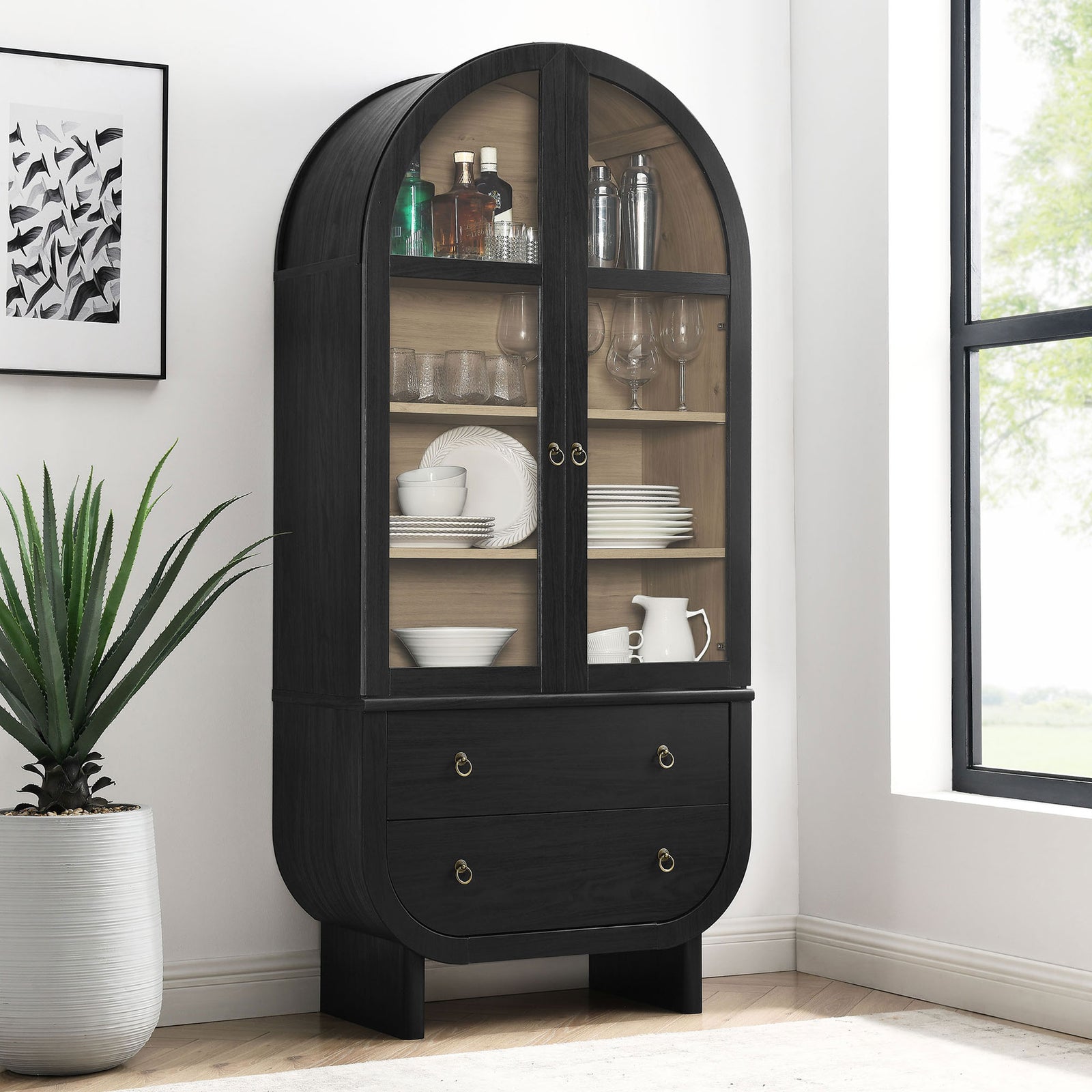Nyx black arched display cabinet styled with dinnerware and barware in a bright modern dining space || EEI-7216-BLK-LOA || front_angle_room