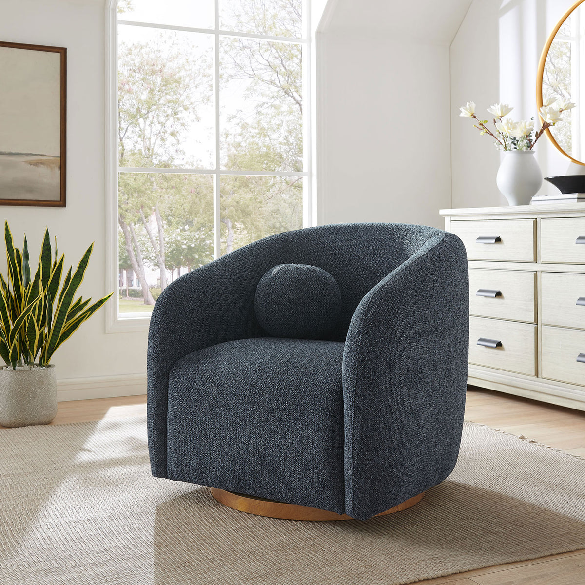 Statement swivel armchair in navy chenille with cozy curves and a warm wood base || EEI-7218-NAV || front_angle_room
