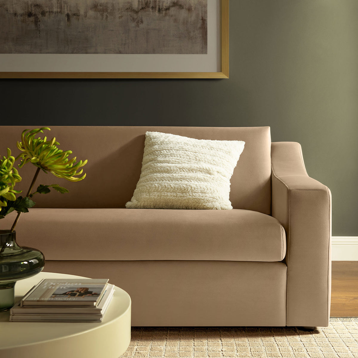 Taupe velvet sofa styled with textured pillow and modern decor, bringing warmth to a cozy living room. || EEI-7219-TAU || detail_room