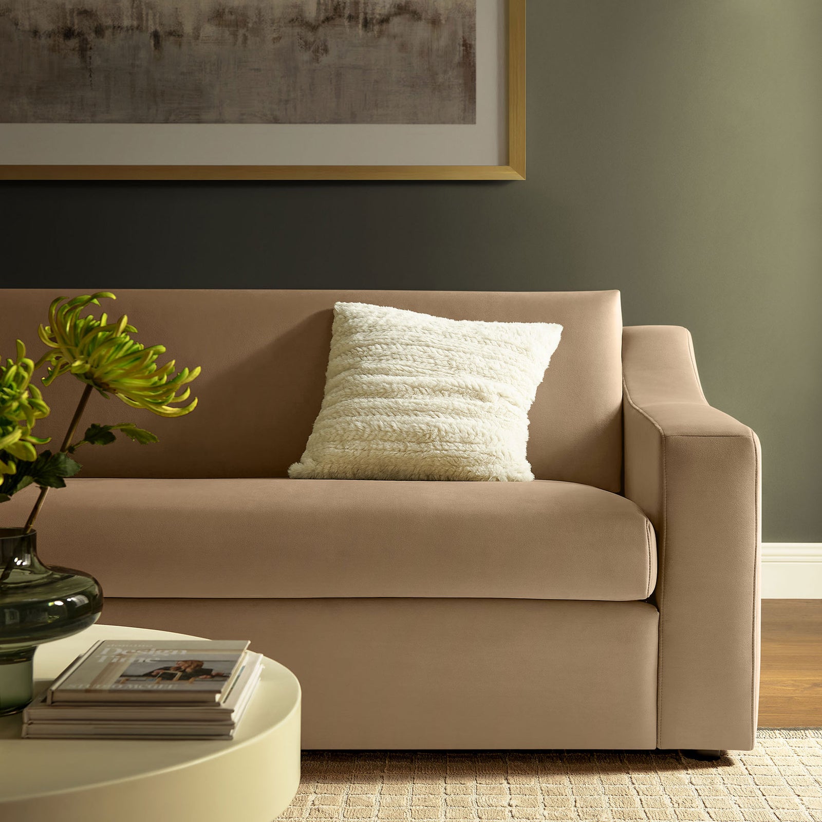 Taupe velvet sofa styled with textured pillow and modern decor, bringing warmth to a cozy living room. || EEI-7219-TAU || detail_room