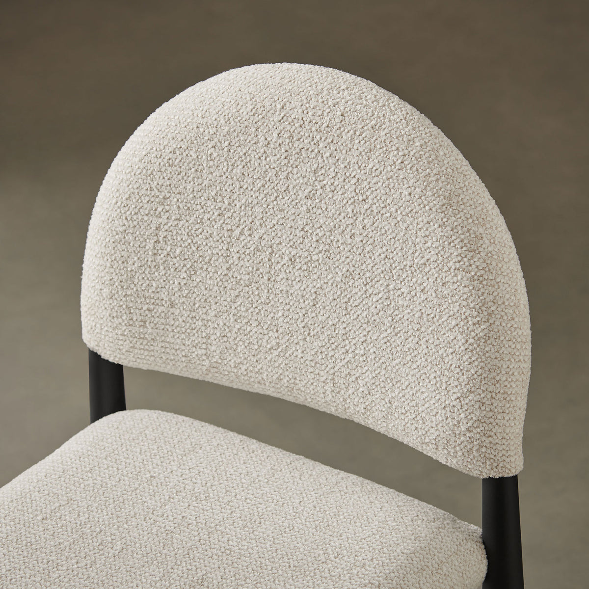 Close-up of cream boucle texture and curved backrest, styled to complement warm, modern interiors || EEI-7221-BLK-CRE || detail_room