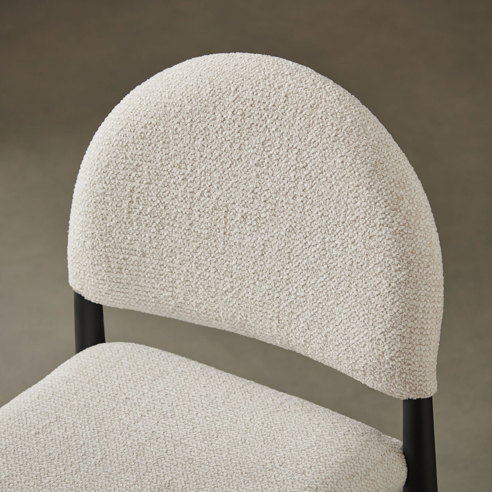 Close-up of cream boucle texture and curved backrest, styled to complement warm, modern interiors || EEI-7221-BLK-CRE || detail_room