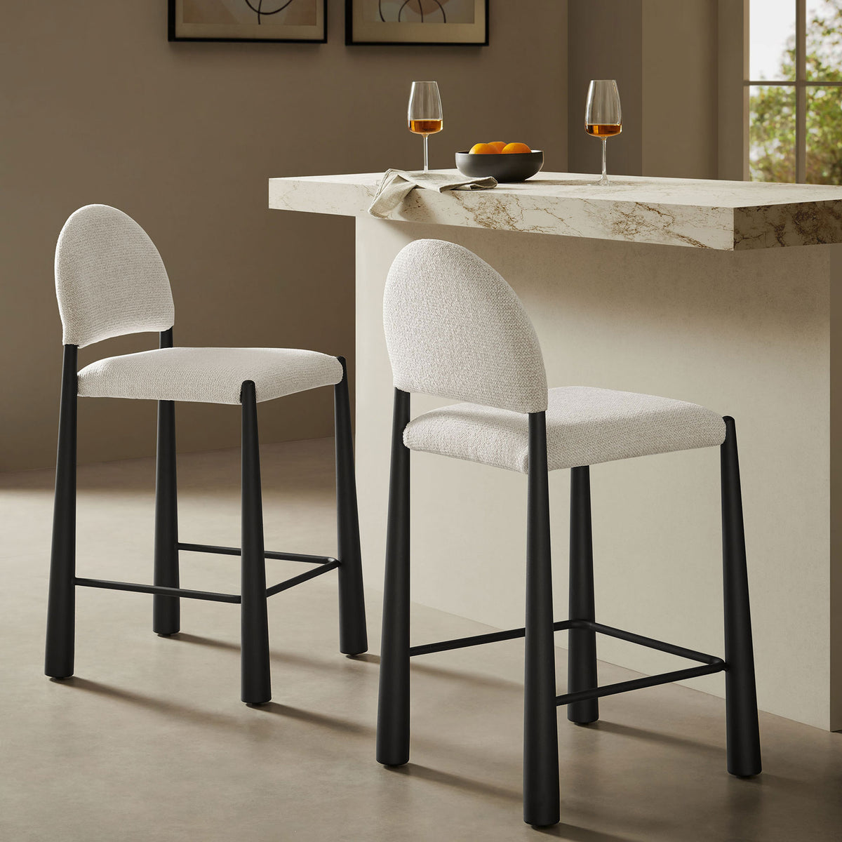 Crisp cream upholstery and matte black legs define this counter stool in a contemporary kitchen setting || EEI-7221-BLK-CRE || front_angle_room