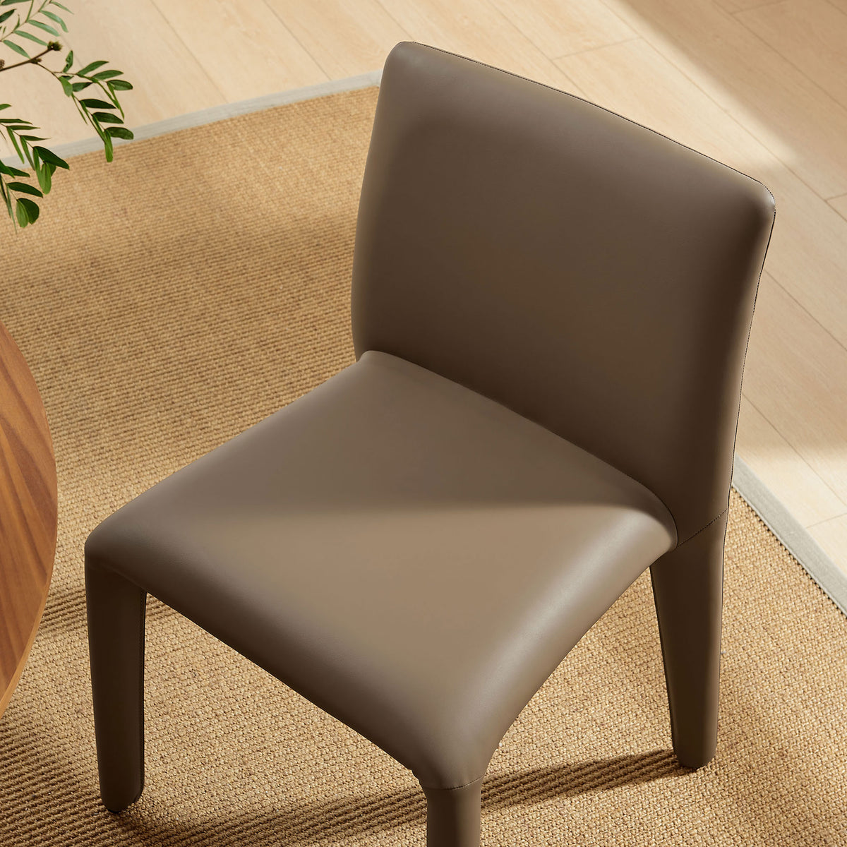 Mushroom brown dining chair styled in a modern dining room, showing its smooth seat and softly rounded back || EEI-7223-MUS || detail_room