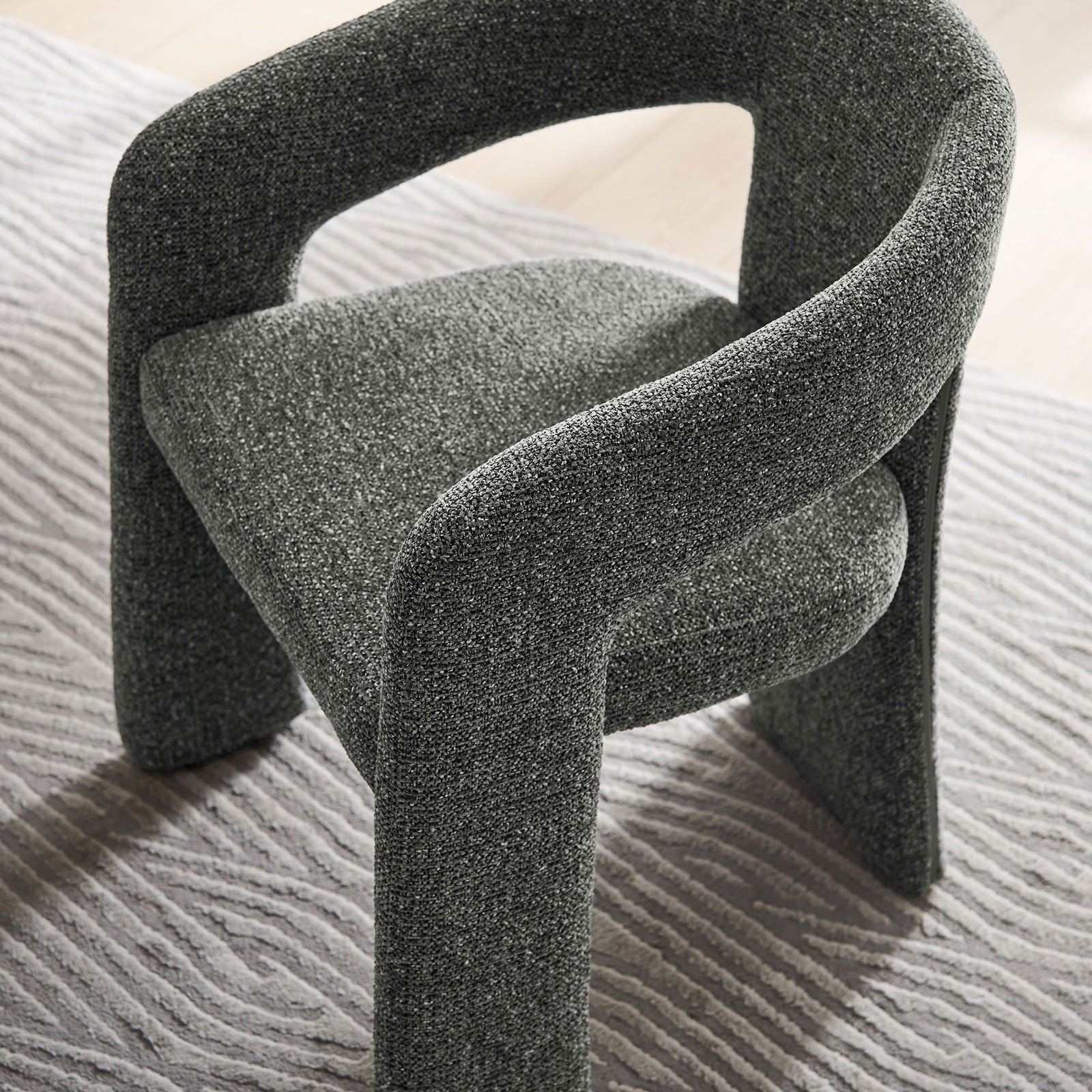 Oslo barrel accent chair in anthracite fabric styled on a patterned area rug for a cozy modern look || EEI-7224-ANT || top_angle_room