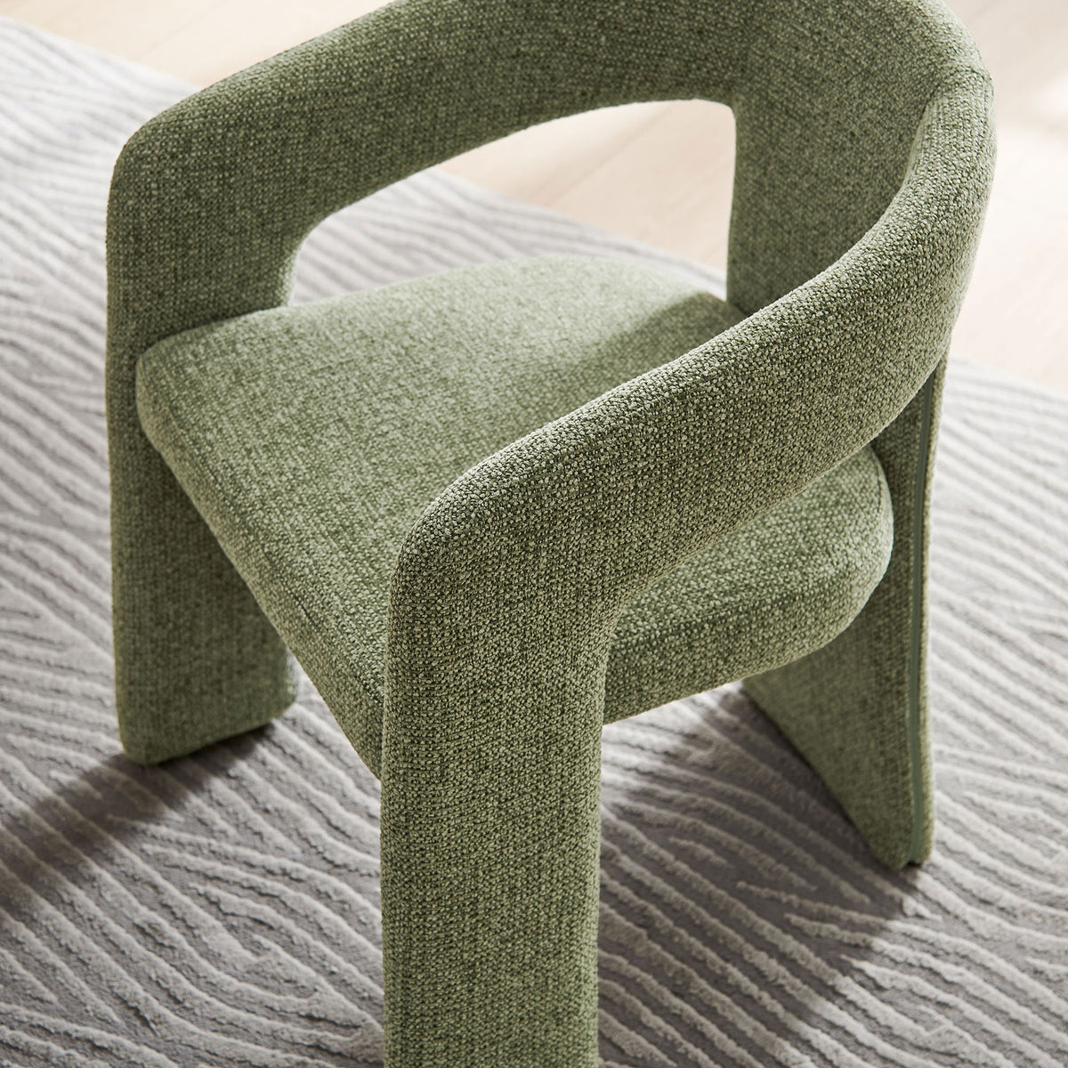 Leaf green barrel chair over a patterned rug, adding soft texture and color to the room decor || EEI-7224-LEA || top_angle_room
