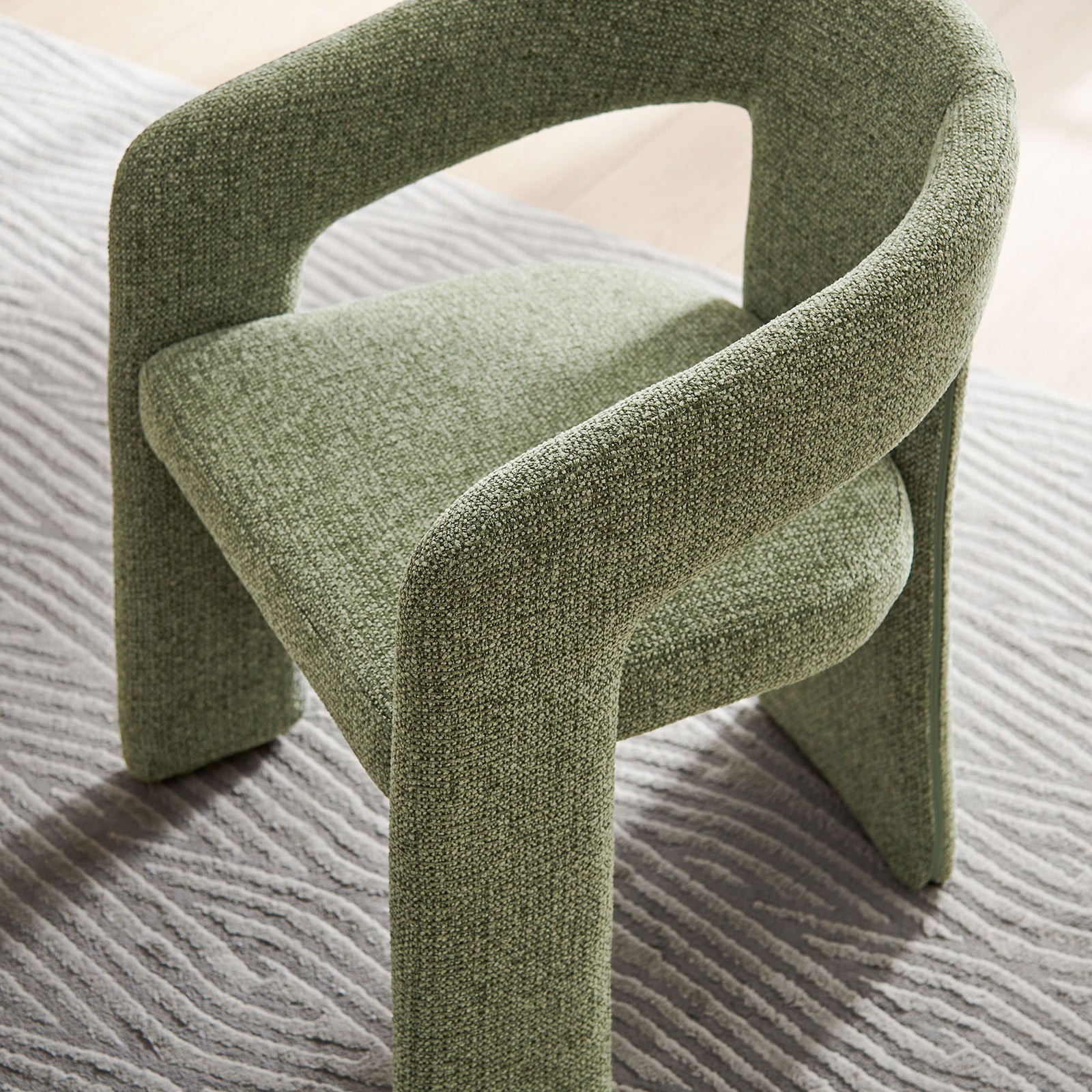 Leaf green barrel chair over a patterned rug, adding soft texture and color to the room decor || EEI-7224-LEA || top_angle_room
