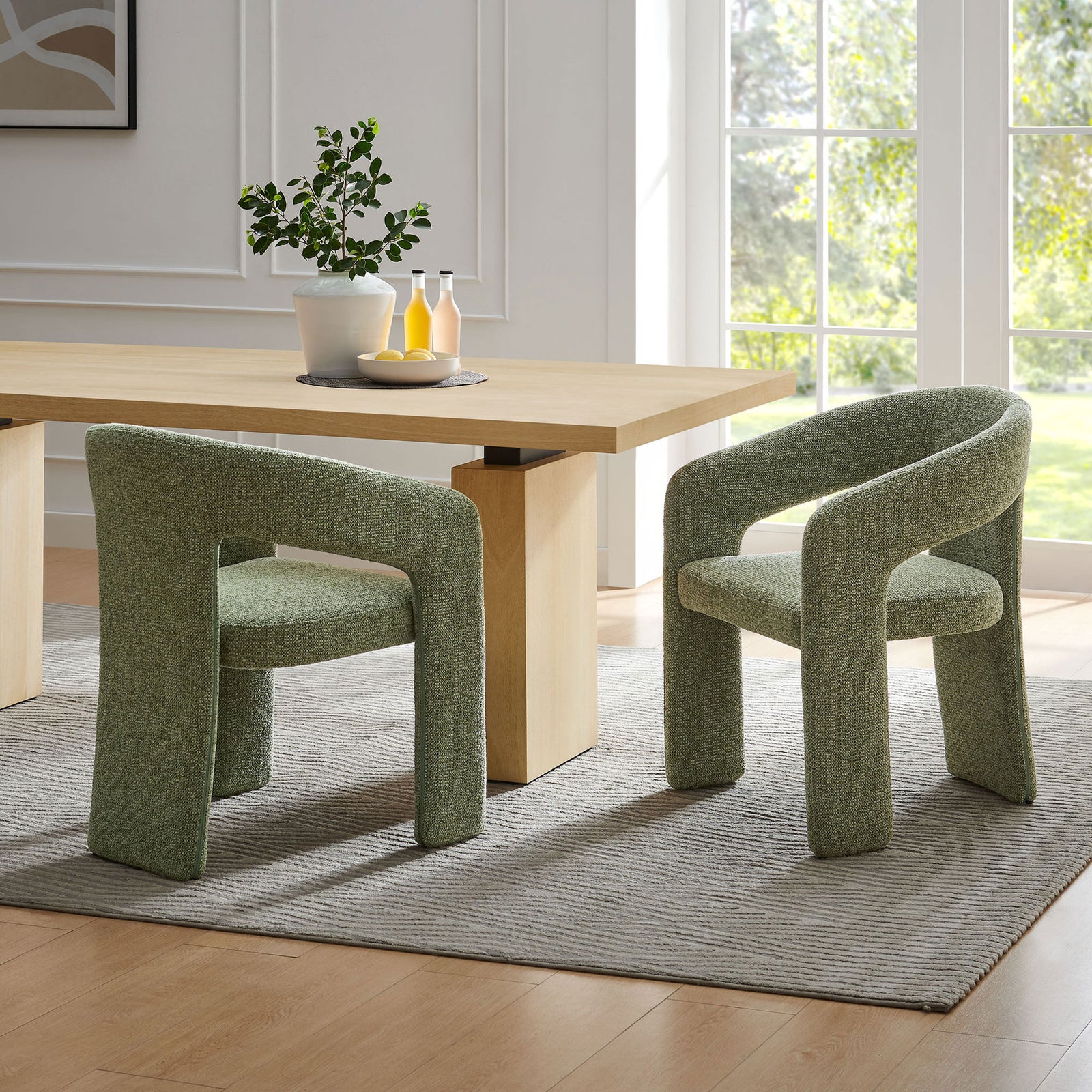 Two leaf green barrel dining chairs styled around a light wood table to create a warm, modern dining area || EEI-7224-LEA || front_angle_room