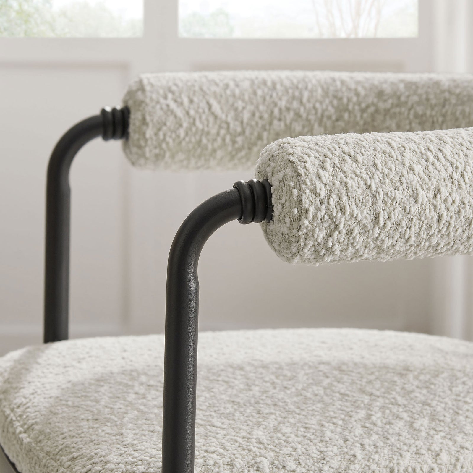 Nubby boucle barrel back softens the clean black frame for a cozy, modern touch in the dining space || EEI-7225-BLK-PRL || detail_room
