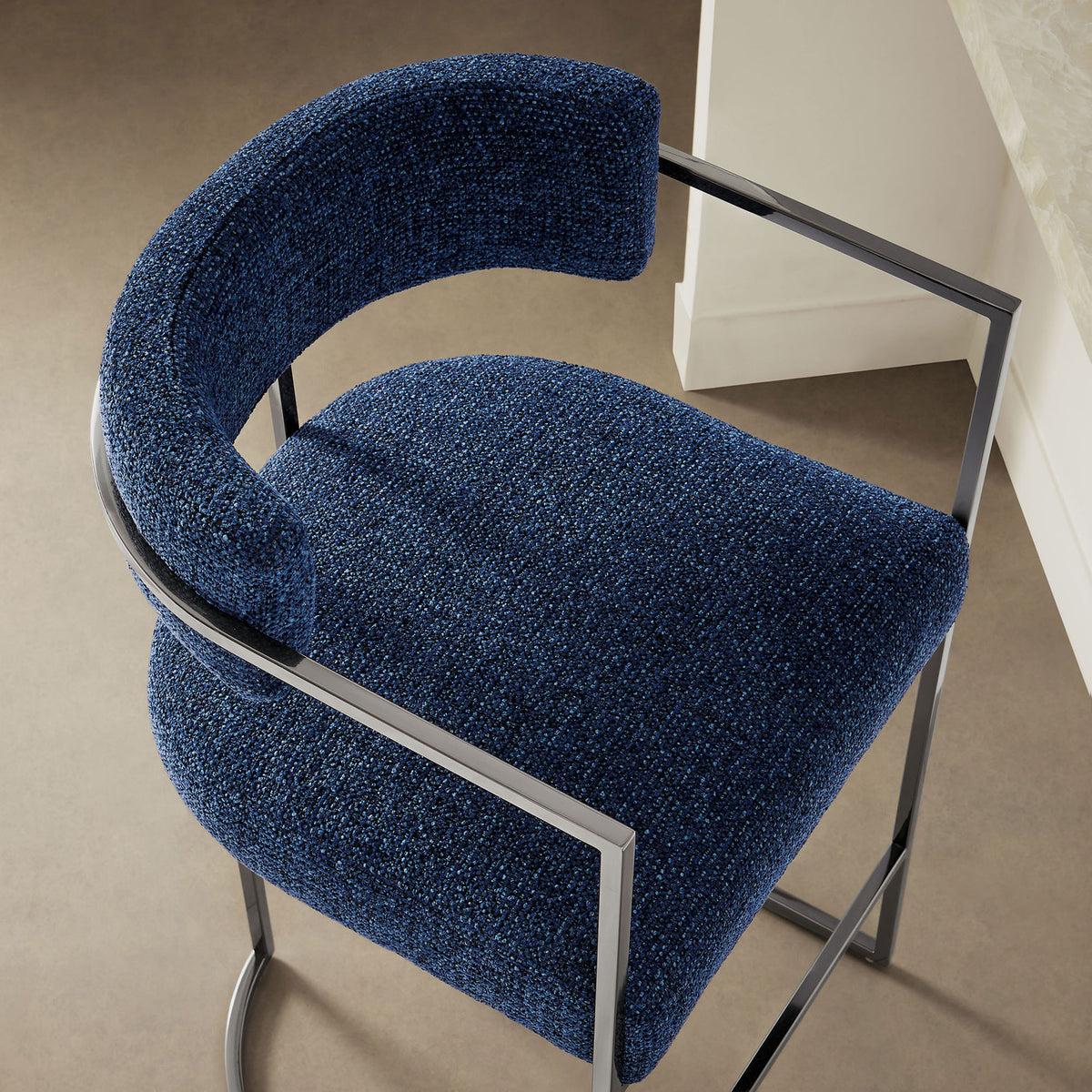 Plush navy upholstery and curved back bring tactile depth to contemporary kitchens || EEI-7227-SLV-NAV || detail_room