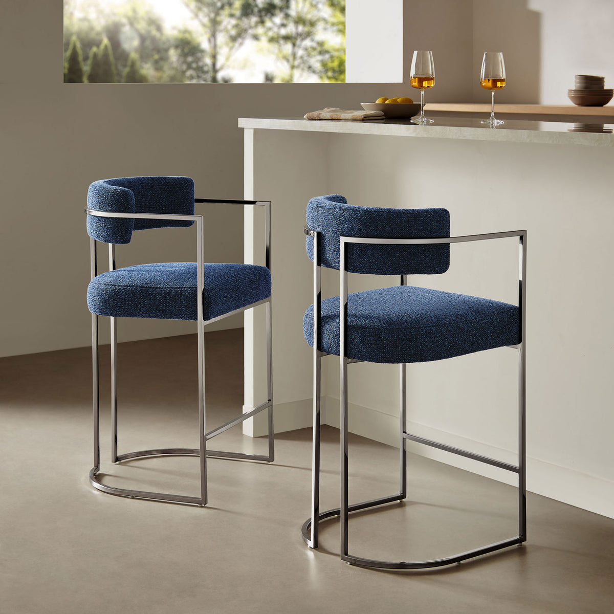 Modern counter stool elevates a kitchen island with plush navy seat and airy chrome base || EEI-7227-SLV-NAV || front_angle_room