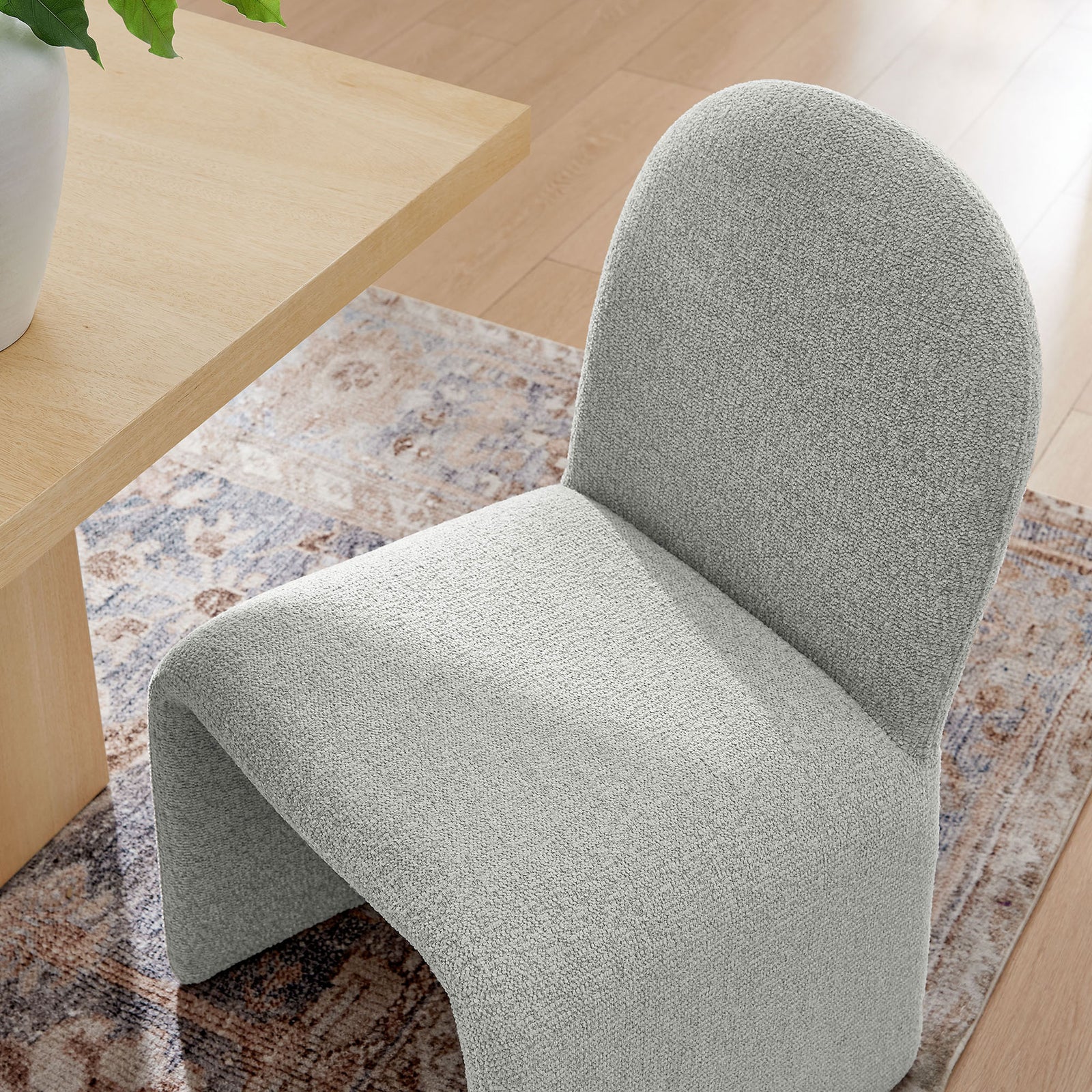 Dove gray boucle dining chair tucked at a light wood table over a patterned area rug || EEI-7231-DOV || detail_room