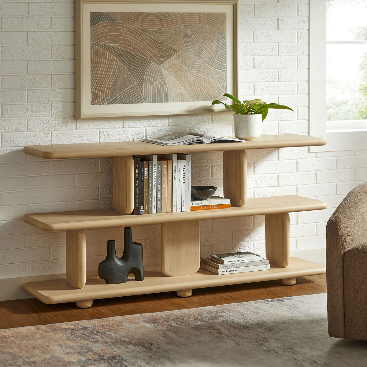 Sculptural natural bookshelf styled with books and decor for a warm, modern look || EEI-7232-NAT || front_room