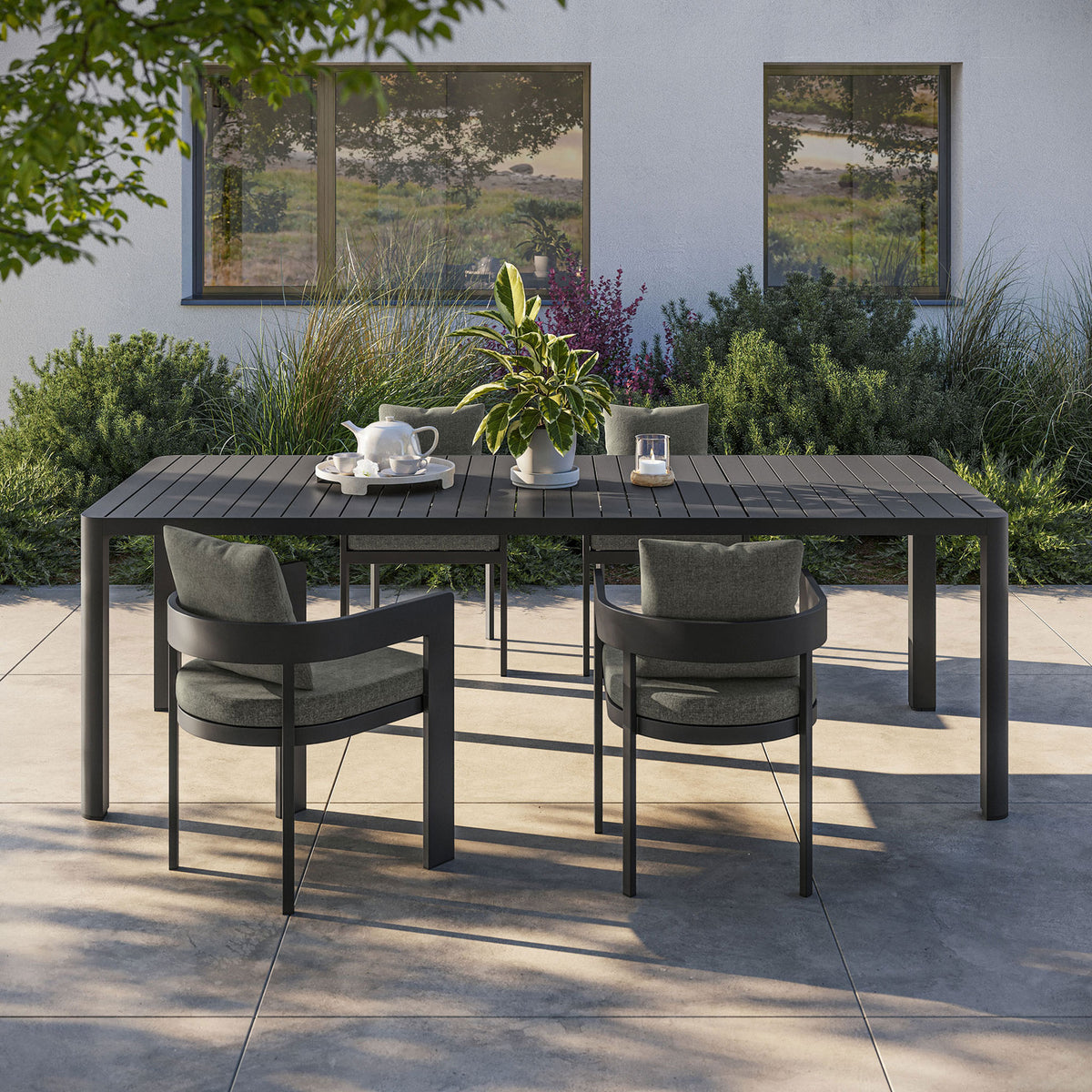 Spacious Tahoe extendable dining table arranged with chairs for stylish outdoor entertaining. || EEI-7236-GRY || front_angle_room