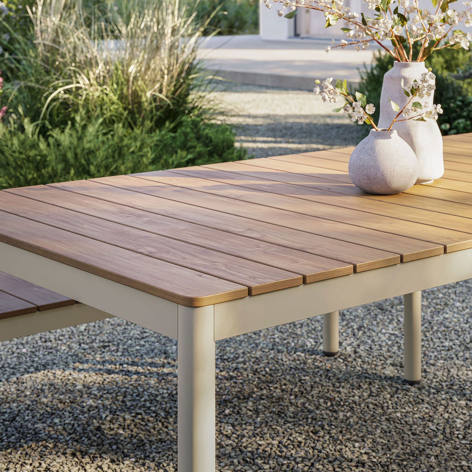Finn dining table with natural slatted top styled with vases on a gravel patio || EEI-7237-NAT || swatch_room