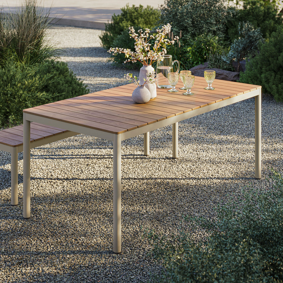 Finn outdoor dining table in a garden setting with natural slatted top and cream frame arranged for entertaining || EEI-7237-NAT || front_angle_room