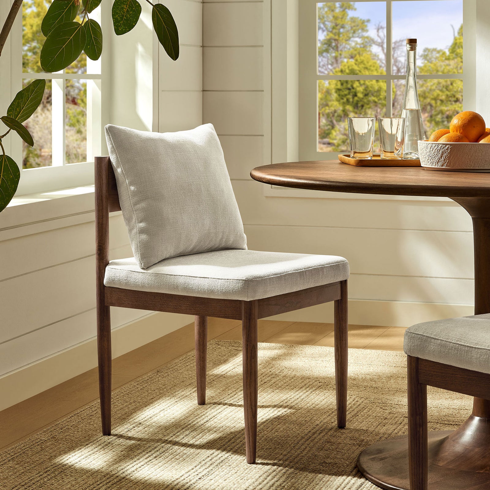 Remington dining chair in salt upholstery pairs with a warm wood table for a relaxed breakfast nook. || EEI-7242-SAL || front_angle_room