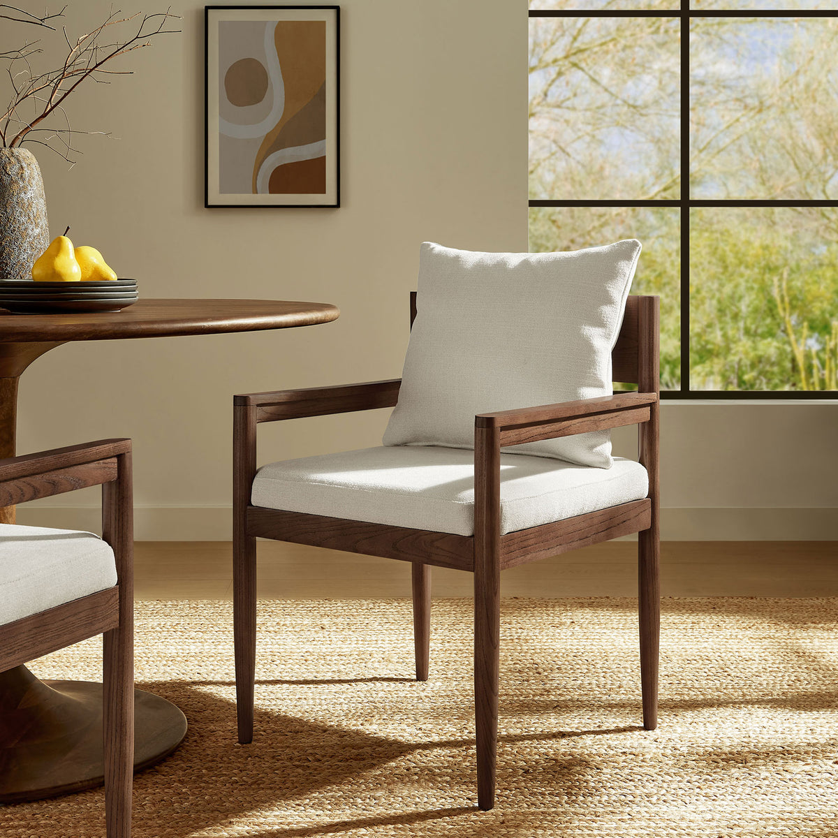 Remington salt fabric dining armchair styled in a warm sunlit dining room setting || EEI-7243-SAL || front_angle_room
