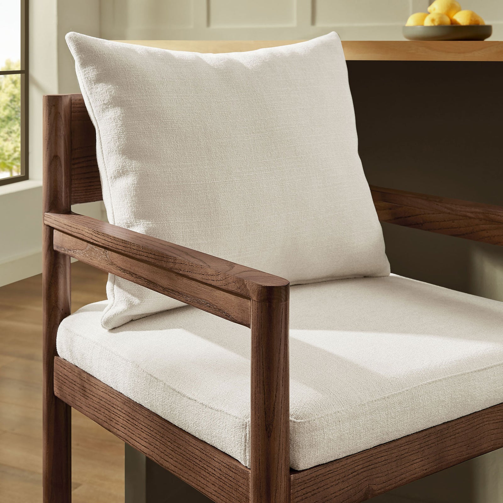 Textured fabric and a sculpted wood armrest create a refined, comfortable spot at the bar || EEI-7245-SAL || detail_room