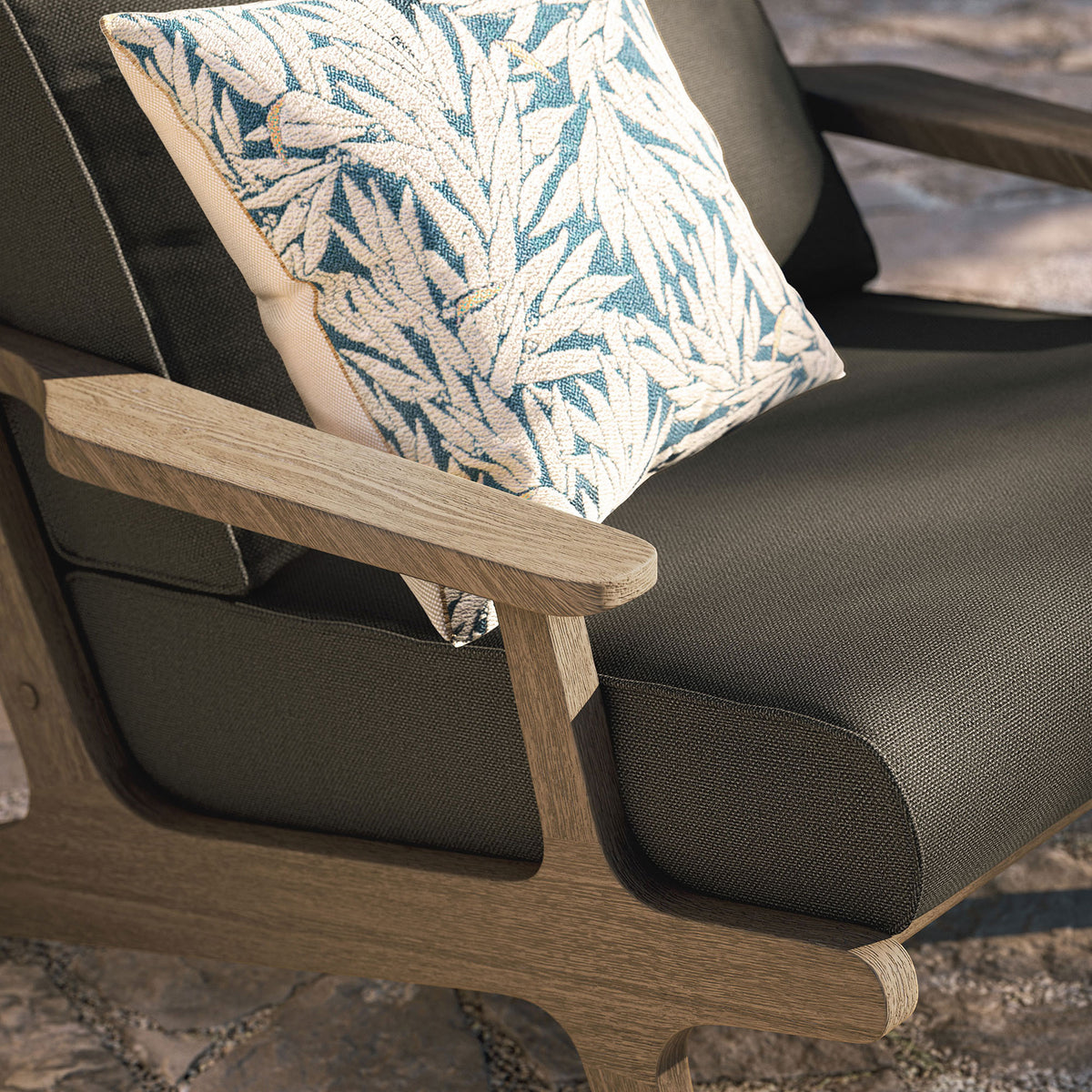 Saratoga flint gray chair armrest and cushion styled with a patterned outdoor throw pillow || EEI-7248-WGR-FLI || detail_room