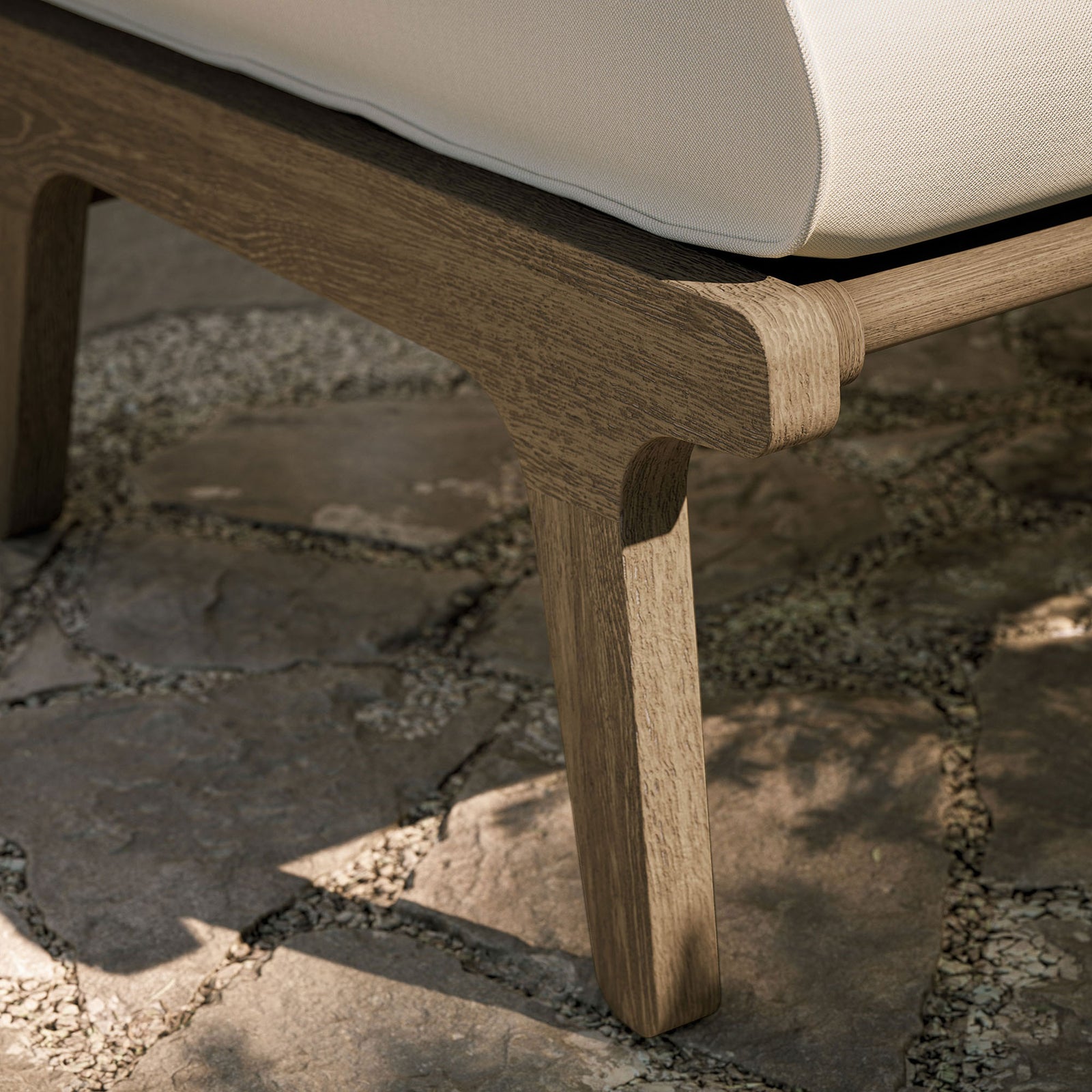 Weathered teak ottoman leg on stone patio, highlighting durable joinery and outdoor ready style || EEI-7250-WGR-WHI || leg_room