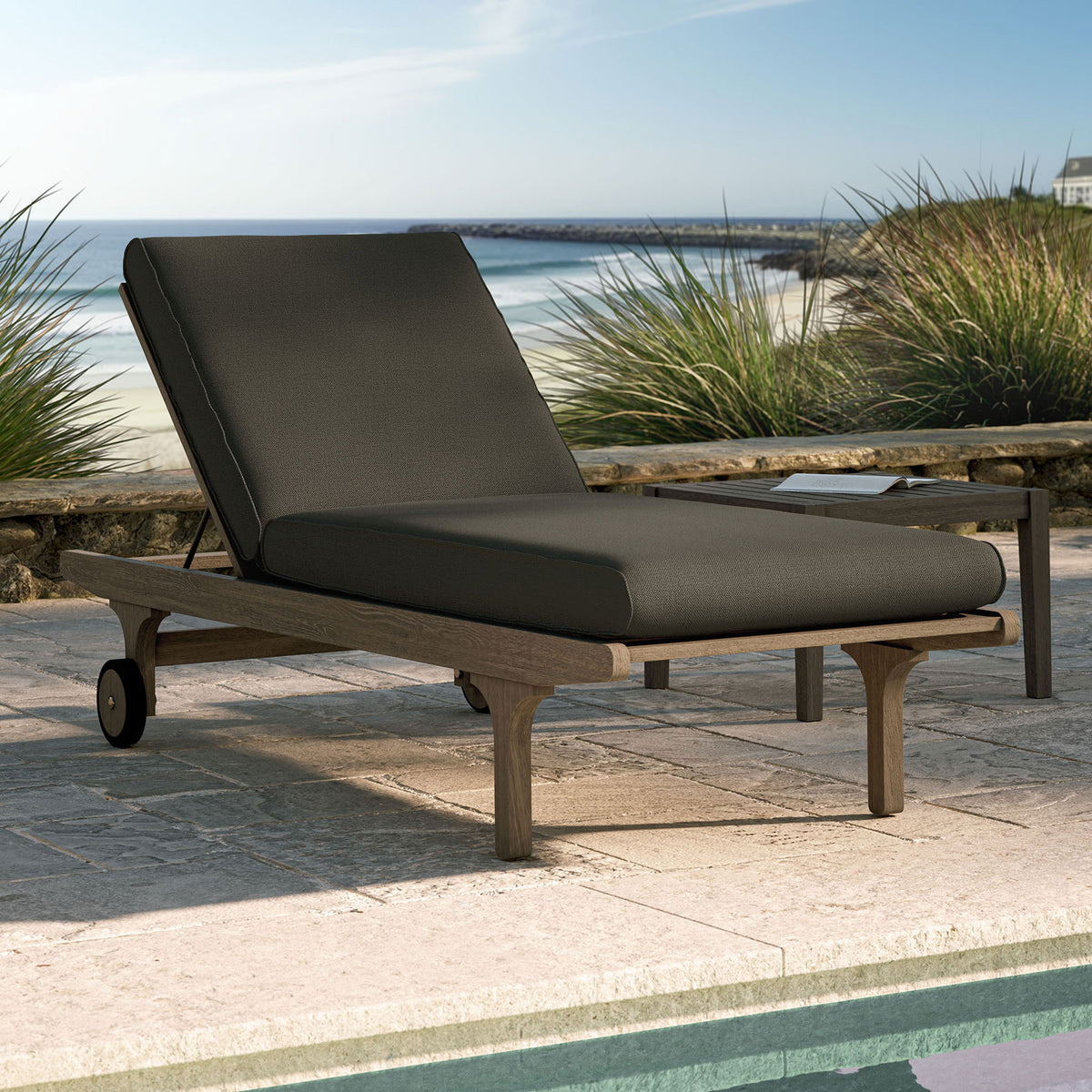 Flint gray cushioned teak chaise lounge styled by a sunlit pool for sophisticated outdoor relaxation || EEI-7251-WGR-FLI || front_angle_room