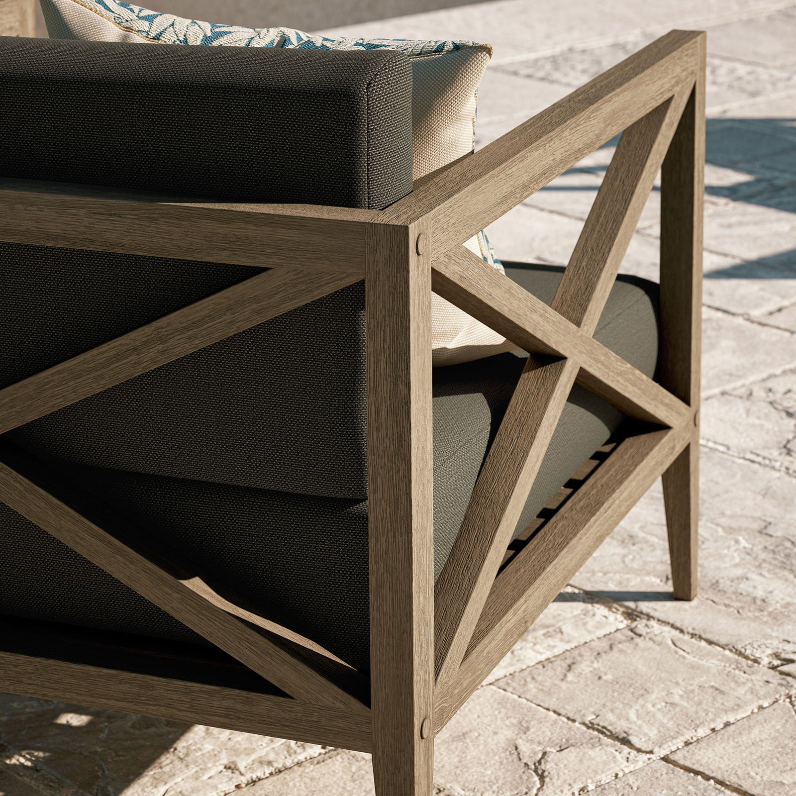 Weathered teak frame and flint gray cushions shown on a sunlit patio, ready for relaxed outdoor lounging || EEI-7252-WGR-FLI || detail_room