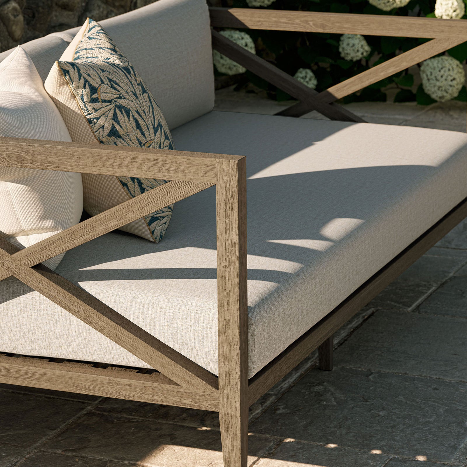 Teak arm and pebble seat cushions styled with accent pillows create an inviting outdoor lounge moment. || EEI-7254-WGR-PEB || detail_room