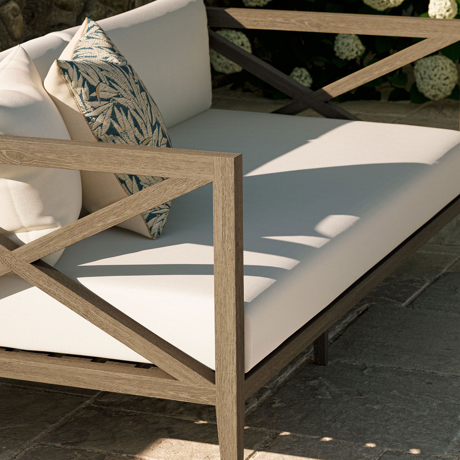 Teak arm and white seat cushions styled with accent pillows create an inviting outdoor lounge moment. || EEI-7254-WGR-WHI || detail_room