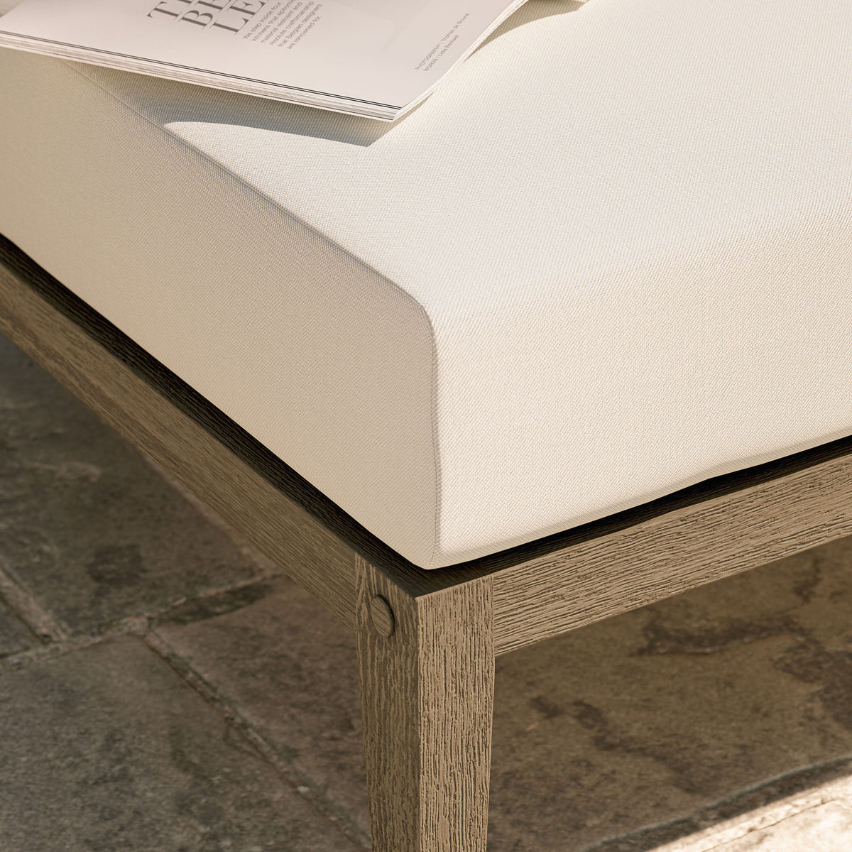 Textured white cushion and teak base bring relaxed comfort to an outdoor stone patio setting || EEI-7255-WGR-WHI || detail_room