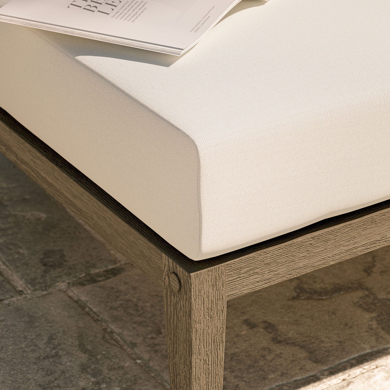 Textured white cushion and teak base bring relaxed comfort to an outdoor stone patio setting || EEI-7255-WGR-WHI || detail_room
