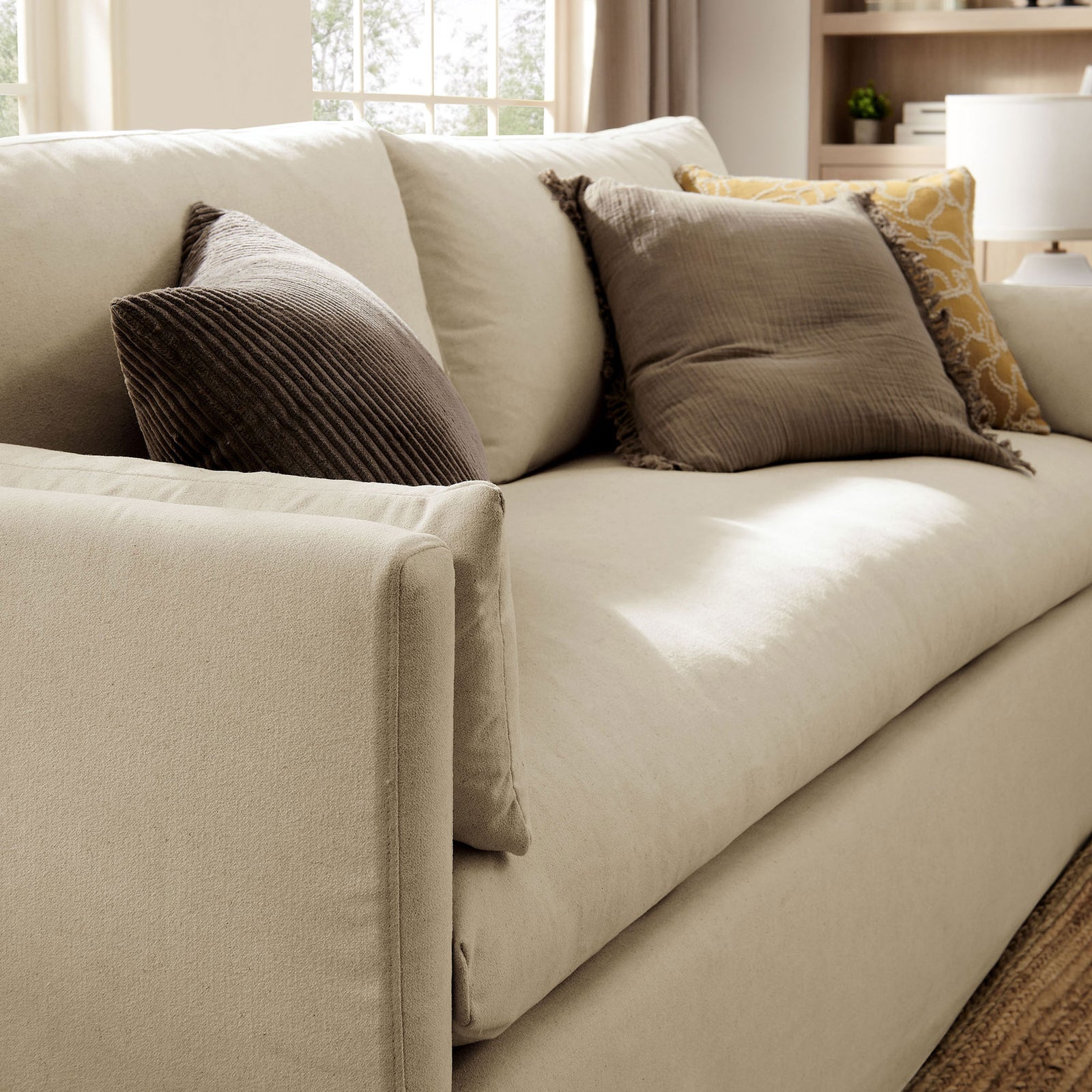 Wellfleet linen sofa styled with layered throw pillows, creating a cozy, inviting seating nook || EEI-7260-LIN || detail_room