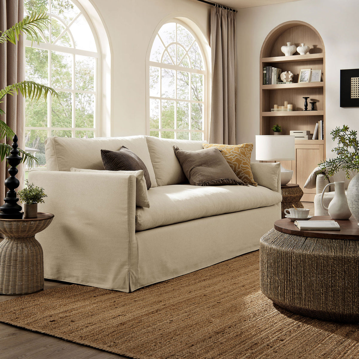 Linen slipcovered sofa anchoring an airy living room with natural textures and warm neutral decor || EEI-7260-LIN || front_angle_room